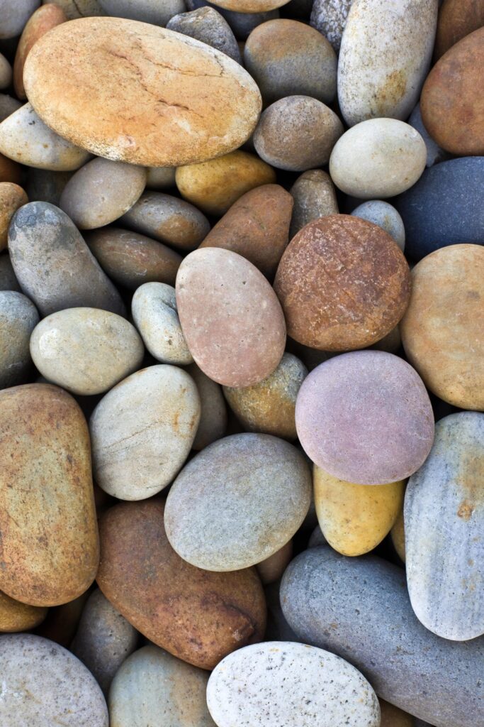 Assortment of smooth rounded river stones in various colors
